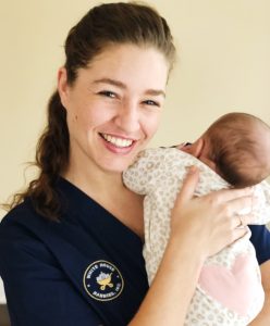 newborn care specialist holding baby
